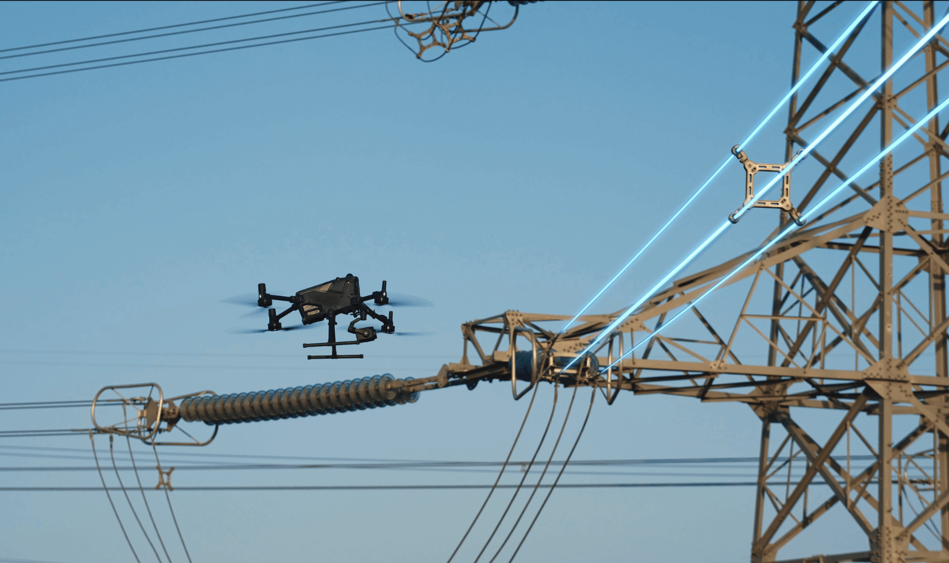 DJI Matrice industrial drone in flight beside a high-voltage transmission tower, inspecting insulators and conductors